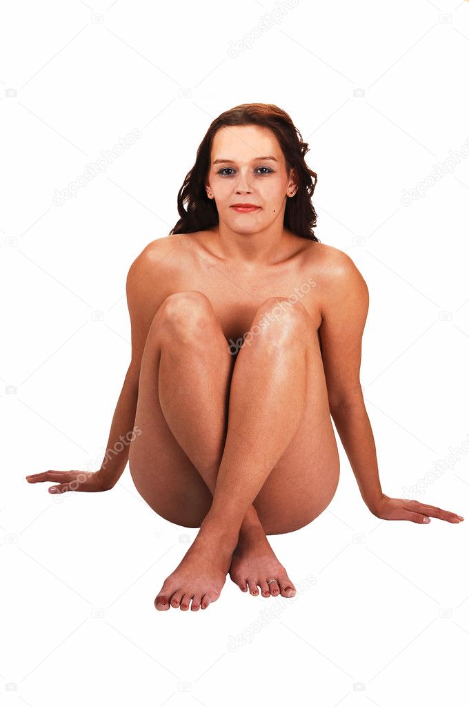 Nude woman sitting on floor.