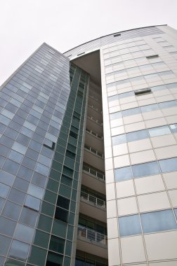 Office building with a hinged facade. clipart