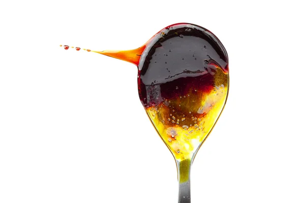 Caramel flowing from the spoon — Stock Photo, Image