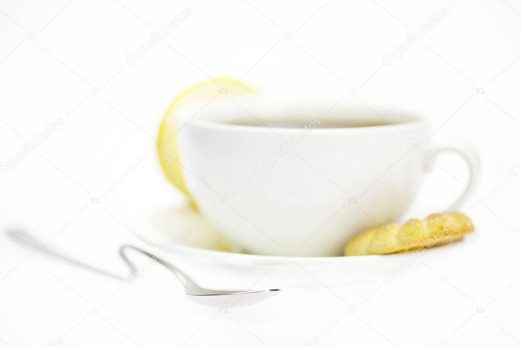 White cup and lemon isolated on white