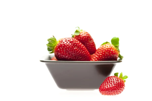 Juicy strawberries in a bowl isolated on white — Stock Photo, Image