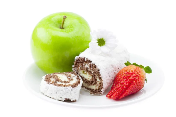 stock image Cake roll, apple and strawberry on a plate