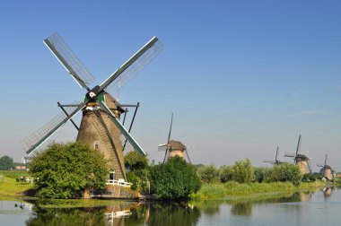 Dutch mills over a river clipart