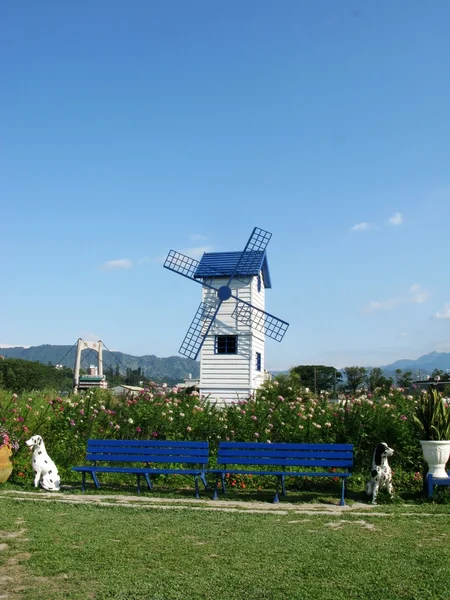 Blue windmill with flower — Stock Photo, Image