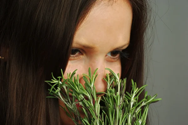 Girl sniffing rosemary — Stock Photo, Image