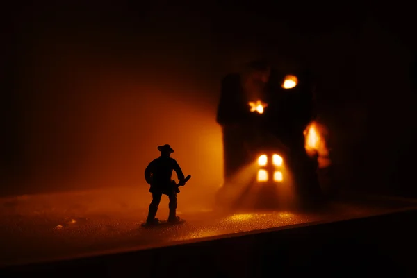 stock image Firefighter run onto the burning house