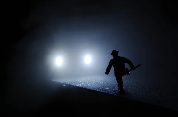 stock image Firefighter run onto car lights in mist