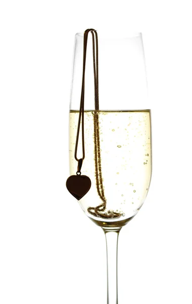 Wineglass with sparkling wine and heart — Stock Photo, Image