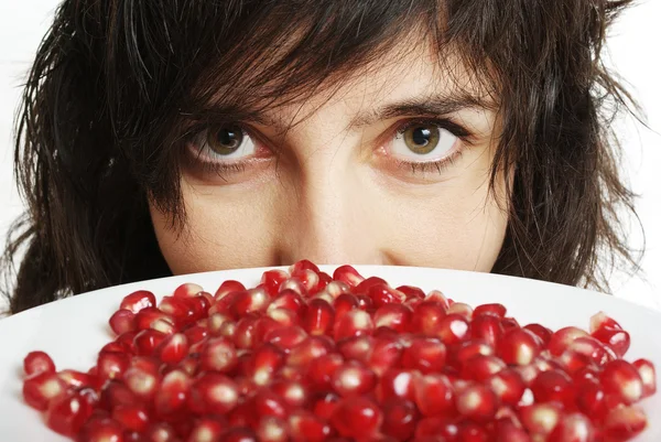 stock image Woman holds pomegranate berries