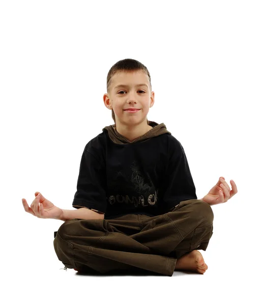 Peaceful boy in yoga pose — Stockfoto