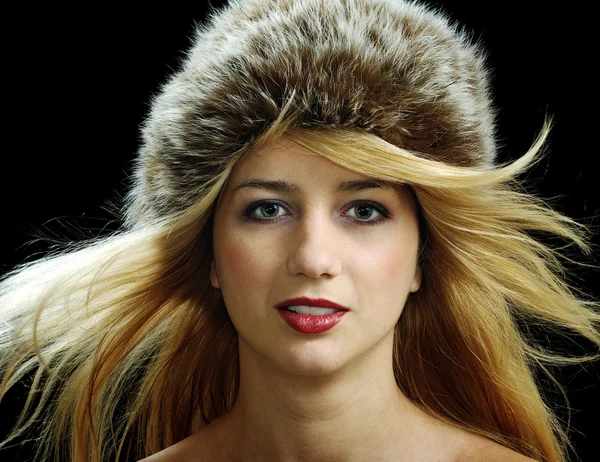 Beutiful blonde in fur hat with naked shoulders — Stock Photo, Image