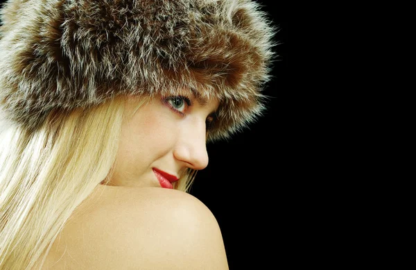 Blonde girl profile portrait in fur hat with naked shoulders — Stock Photo, Image