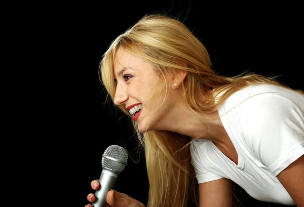 Blonde girl singing karaoke — Stock Photo, Image