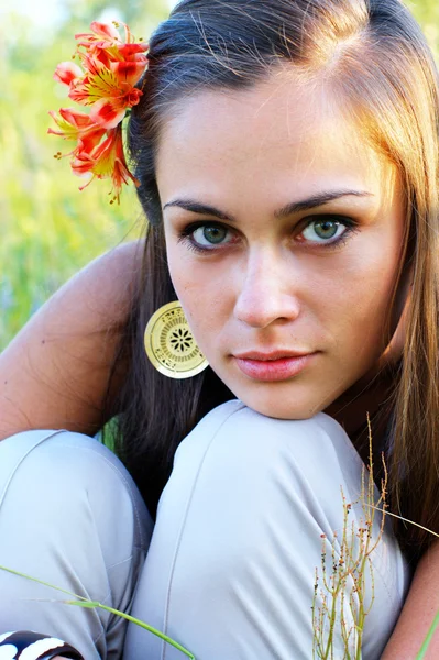 Girl with lily in her hair — Stock Photo, Image