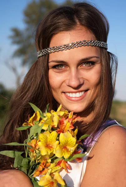 Hippie girl with lily outdoors — Stock Photo, Image