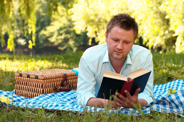 stock image Young man reads book