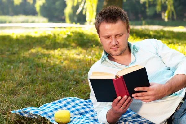 stock image Young man reads book