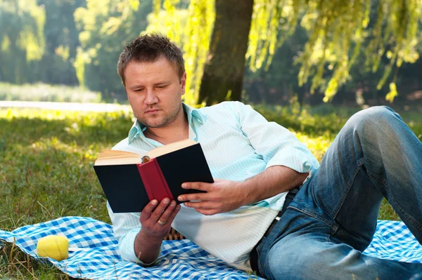 stock image Young man reads book