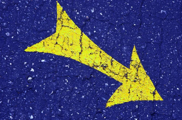 stock image Yellow arrow on the blue asphalt
