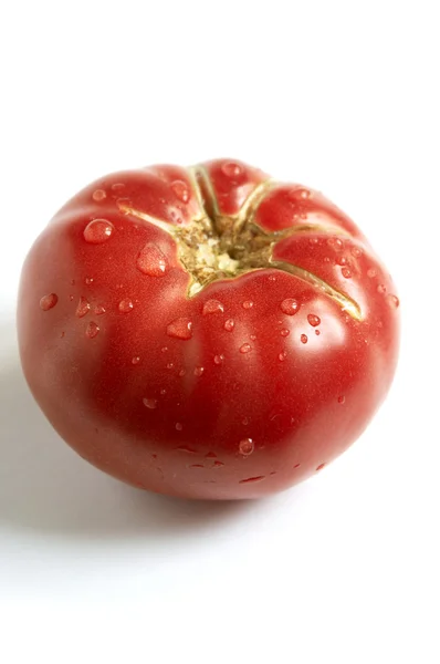 Juicy tomato with droplets — Stock Photo, Image