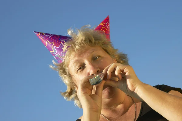Happy woman with noisemaker — Stock Photo, Image