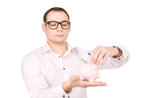 Biznesmen z piggy bank i pieniądze — Zdjęcie stockowe