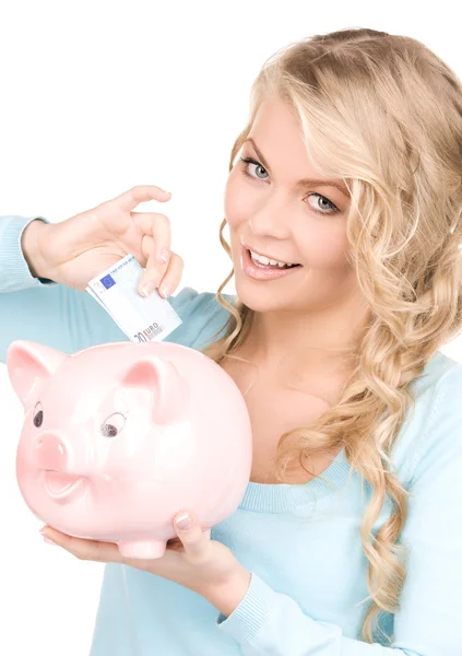 Mulher encantadora com banco porquinho e dinheiro — Fotografia de Stock
