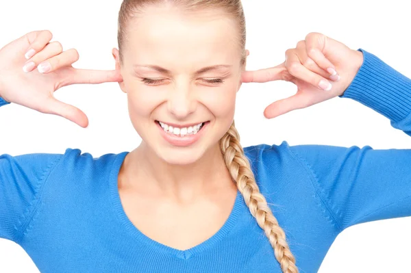 Smiling woman with fingers in ears — Stock Photo, Image