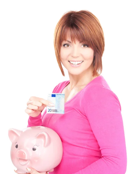 Härlig kvinna med spargris och pengar — Stockfoto