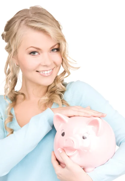 Lovely woman with piggy bank Royalty Free Stock Images