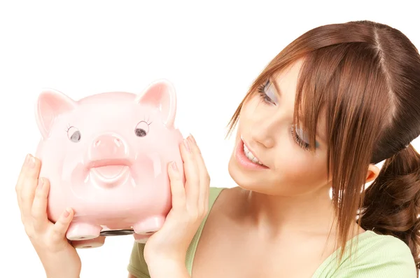 Lovely teenage girl with piggy bank — Stock Photo, Image