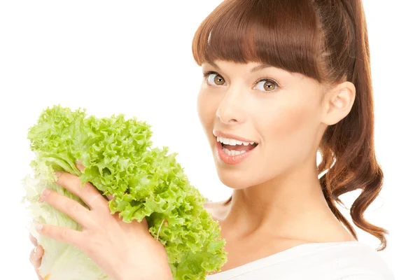 Beautiful housewife with lettuce over white Stock Picture