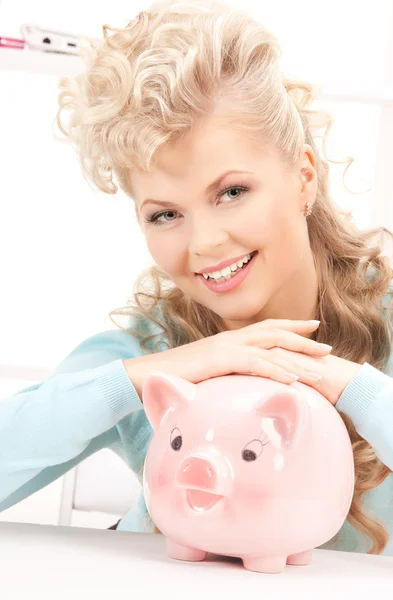 Lovely woman with piggy bank Royalty Free Stock Photos