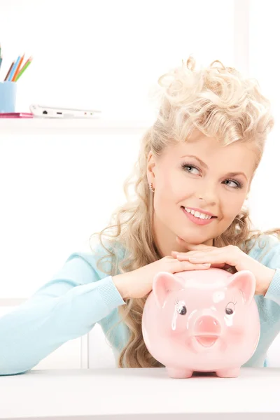 Lovely woman with piggy bank Stock Image
