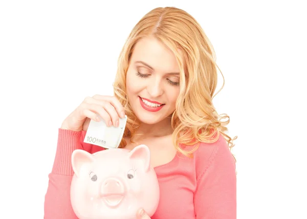 Krásná žena s prasátko a peníze — Stock fotografie