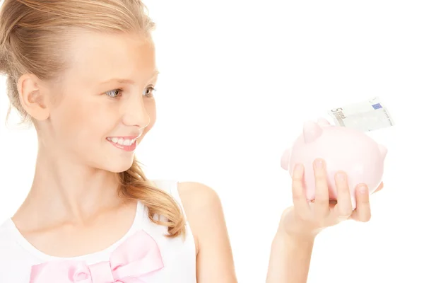 貯金箱とお金と素敵な 10 代の少女 — ストック写真