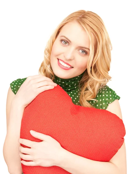 Woman with red heart-shaped pillow — Stock Photo, Image