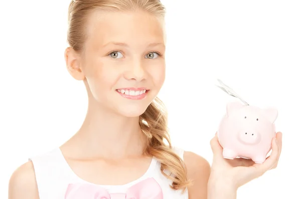 Lovely teenage girl with piggy bank and money — Stock Photo, Image