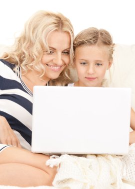 Happy mother and child with laptop computer clipart