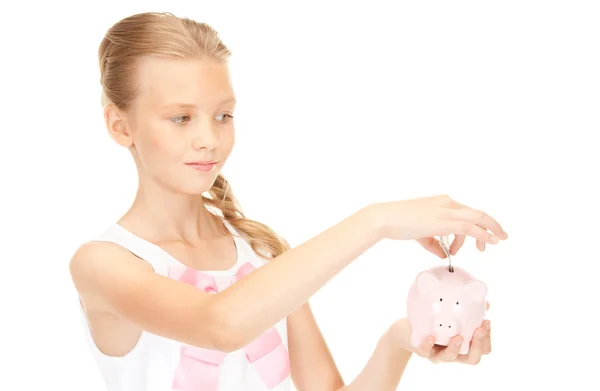Linda menina adolescente com banco porquinho e dinheiro — Fotografia de Stock