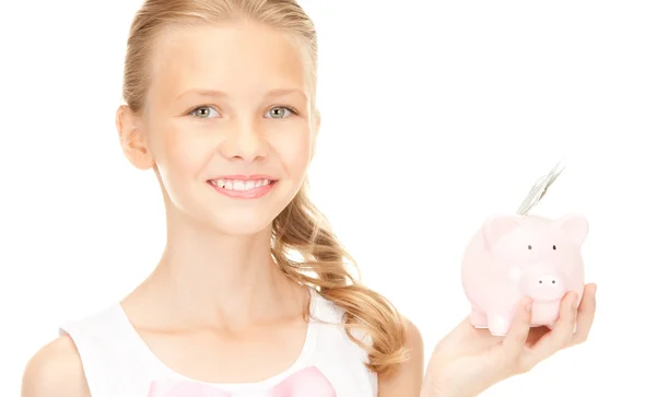 Linda menina adolescente com banco porquinho e dinheiro — Fotografia de Stock