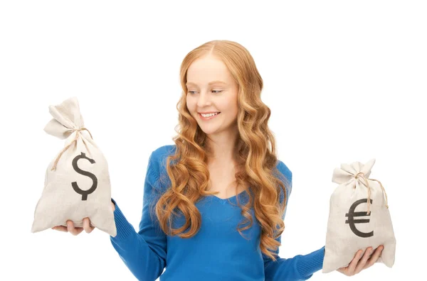 Woman with euro and dollar bags — Stock Photo, Image