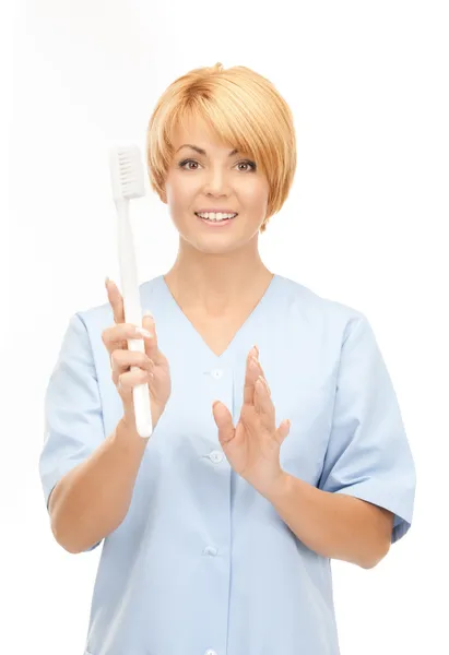 Doktor diş fırçası ile — Stok fotoğraf