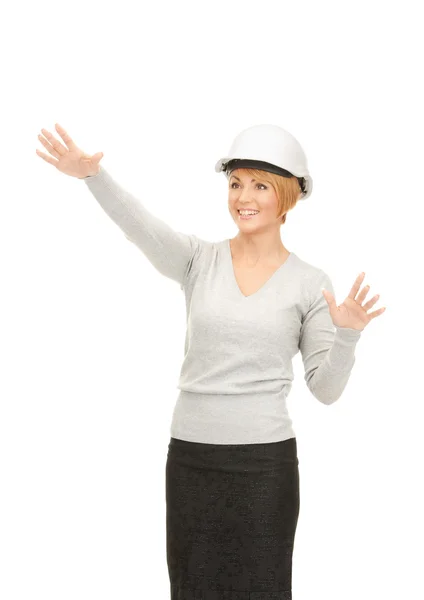 Female contractor in helmet working with something imaginary — Stock Photo, Image