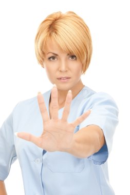 Attractive female doctor showing stop gesture clipart