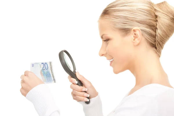 Woman with magnifying glass and money — Stock Photo, Image