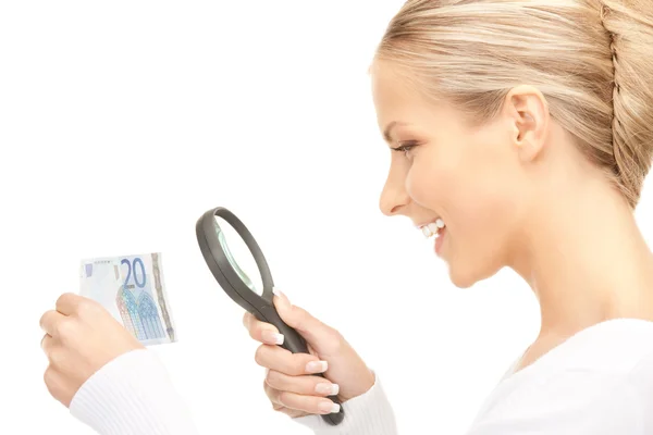 Woman with magnifying glass and money — Stock Photo, Image