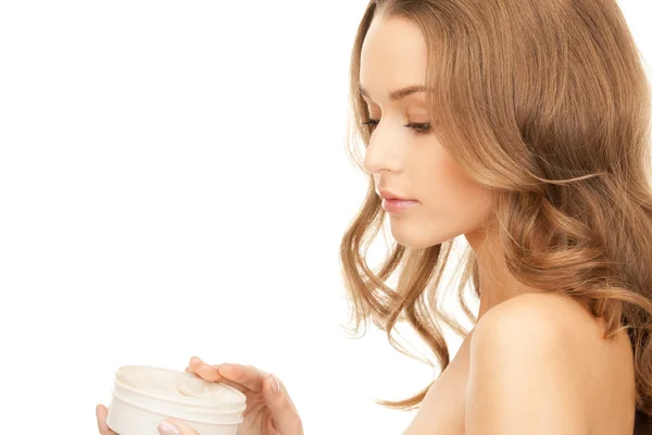 Beautiful woman with moisturizing creme — Stock Photo, Image
