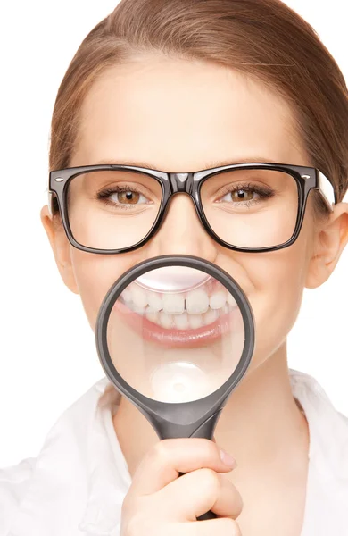 Kvinna med förstoringsglas som visar tänderna — Stockfoto