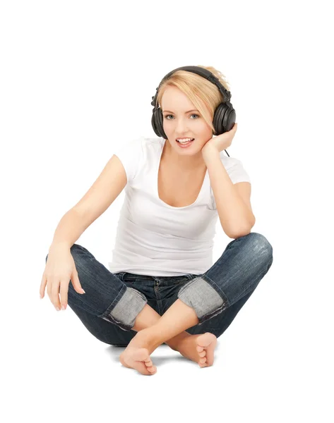 Happy teenage girl in big headphones Stock Image